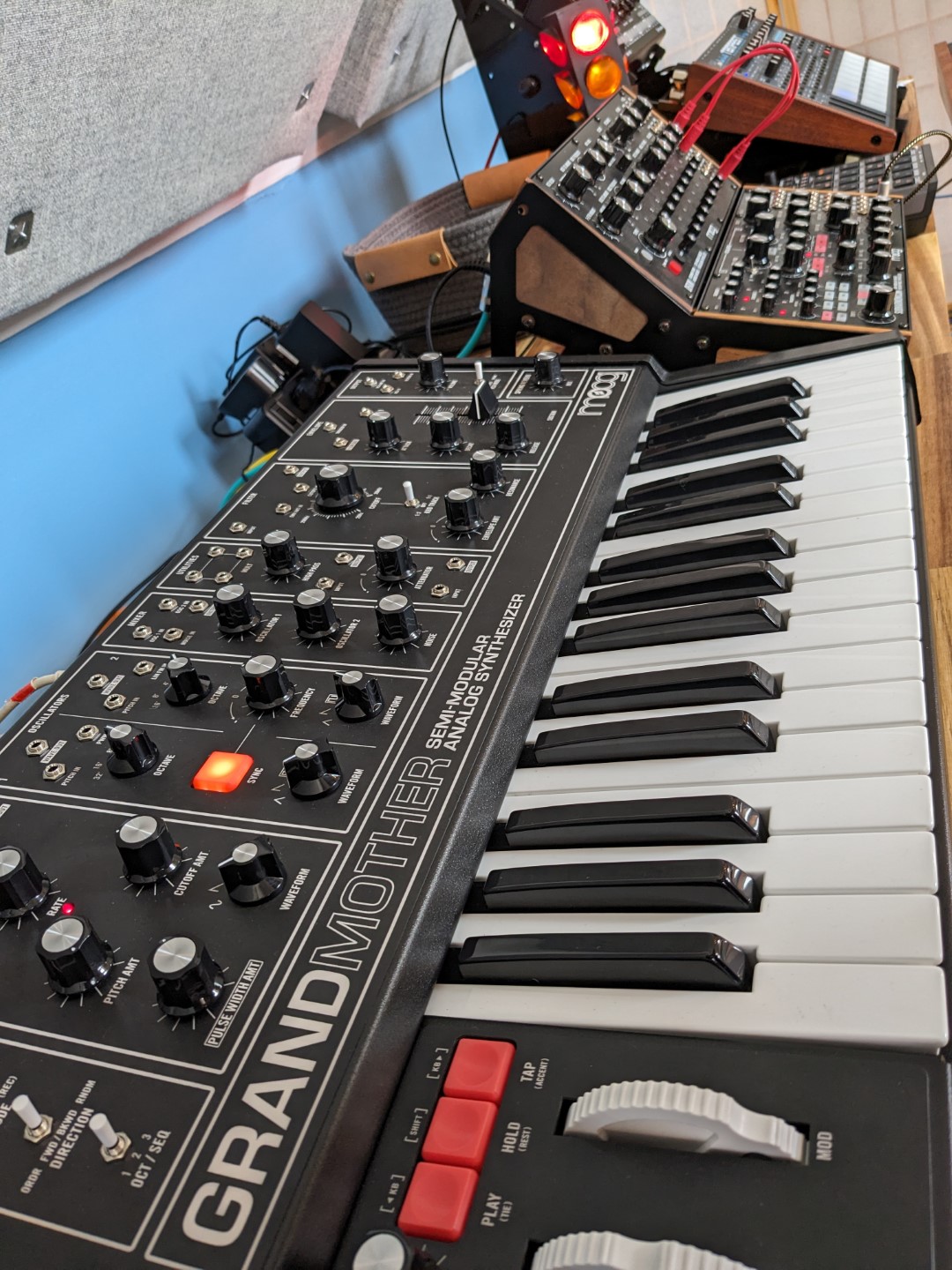 A side view of semi-modular synthesizers on a desk